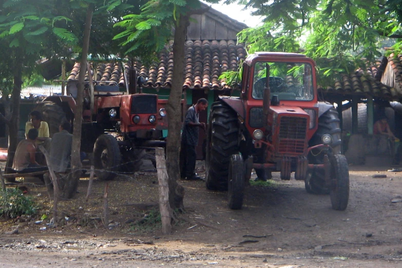 an image of an old tractor parked in the shade