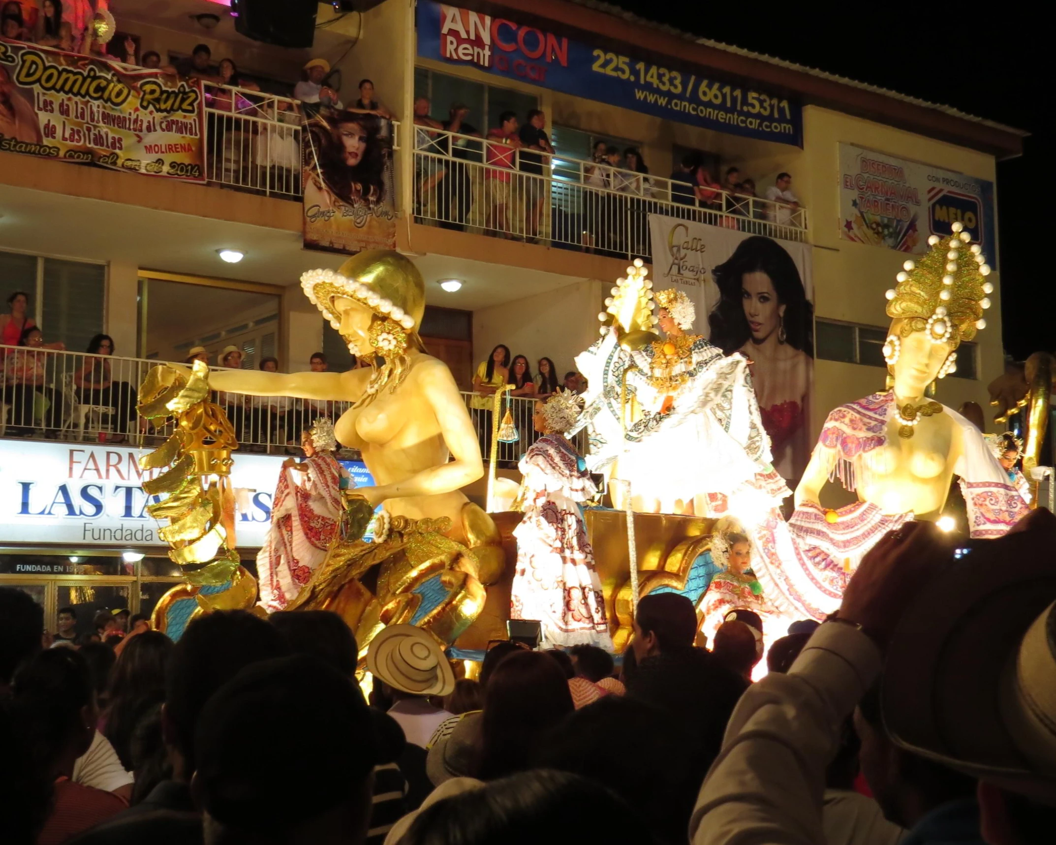 a parade with statues on floaty rides