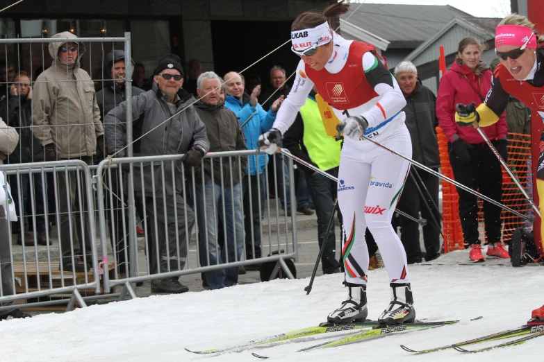 people wearing skis that are on the snow