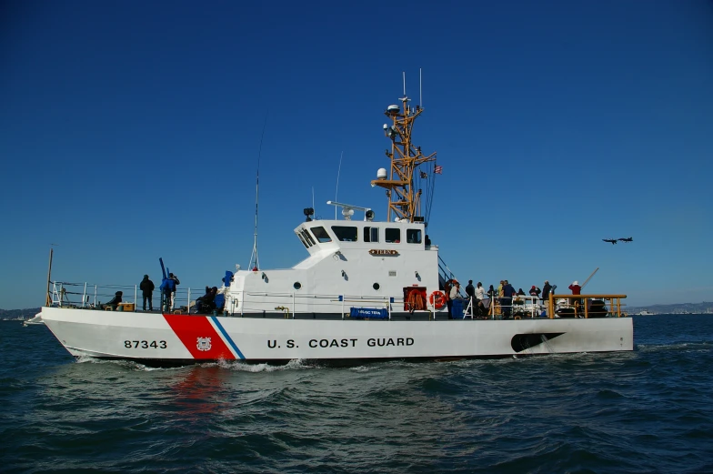 a boat that is in some water with people on it