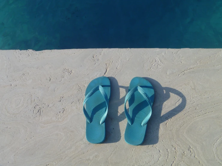 sandals and sandals are laying on the sand