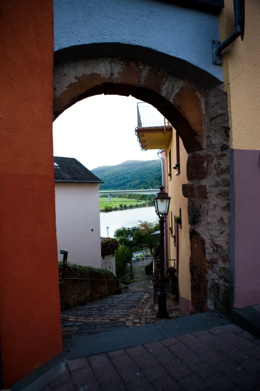 an archway that leads into a town where the road ends