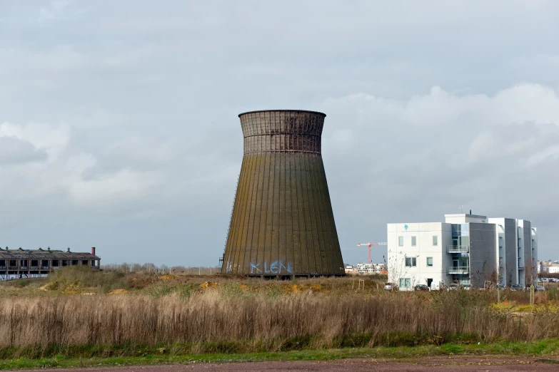 a water tower stands on a grassy plain