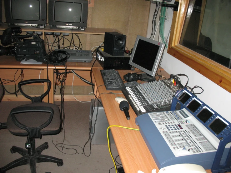 a computer desk full of many electronic devices