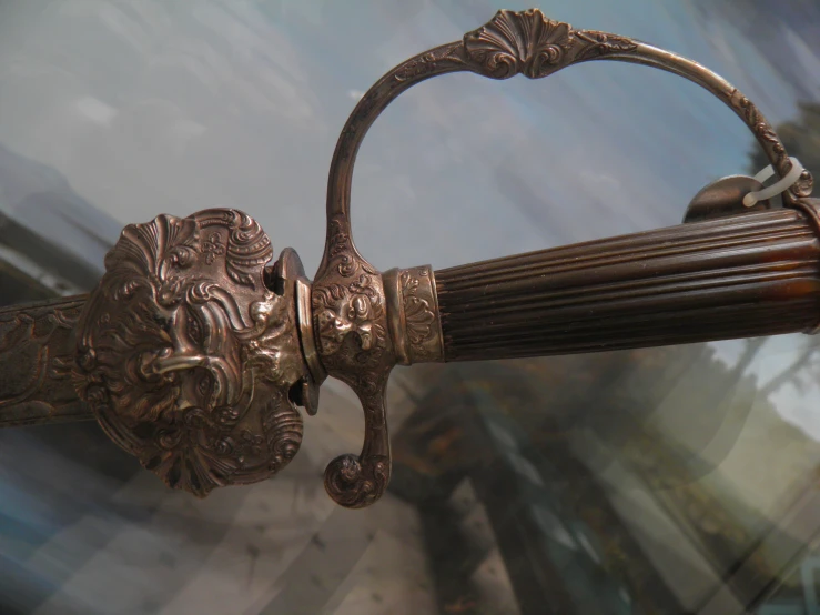 a vintage, ornate metal pole with a lion handle