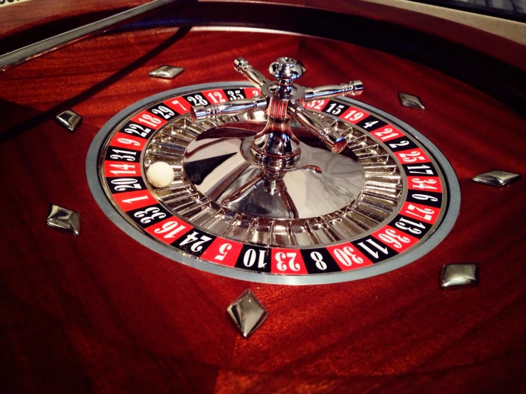 a rouleette table with a spinning wheel for playing cards