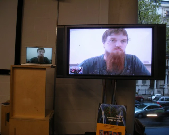 a television screen with a bearded man on it