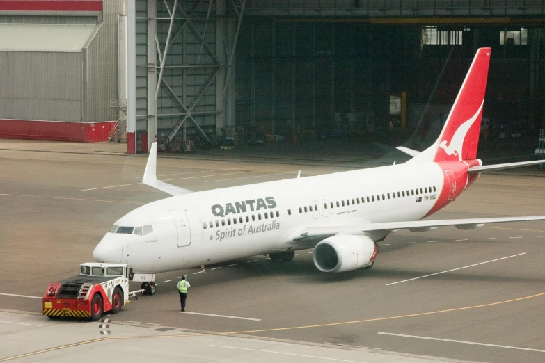 a plane parked at a loading dock in an airplane hangar