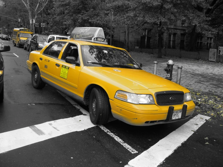 a taxi cab is driving down a city street