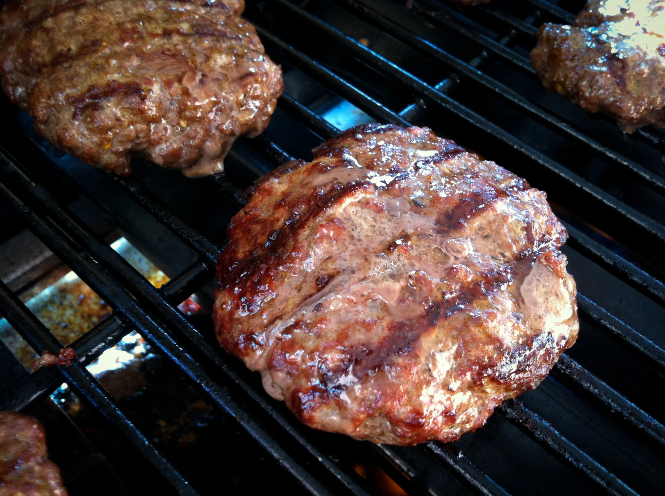 burgers cooking on the grill in a restaurant