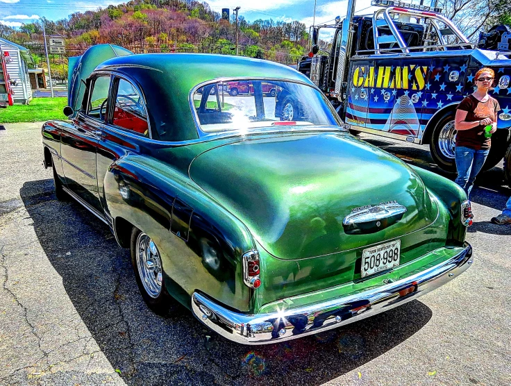 a vintage car in the parking lot at a festival