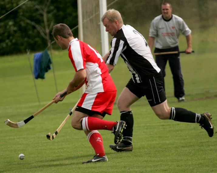 two men on opposing teams are playing with the ball