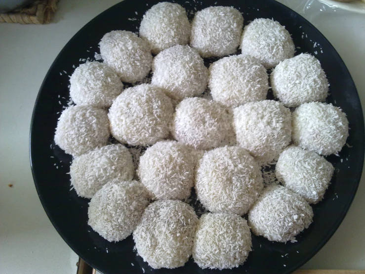 a black plate topped with lots of powdered sugar