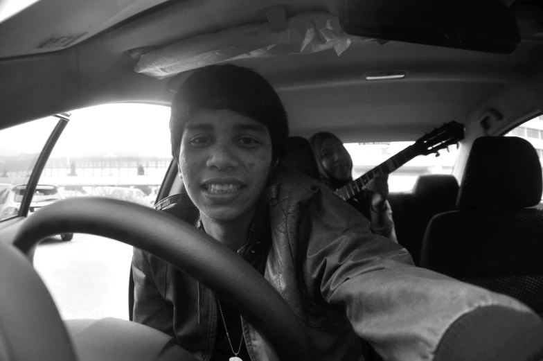 a person in a car, smiling for the camera