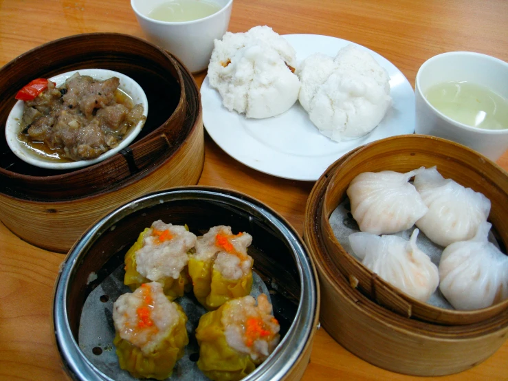 four different foods are placed on a wooden table