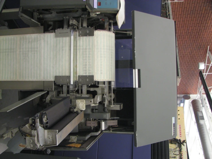 a machine that is making a large sheet of paper