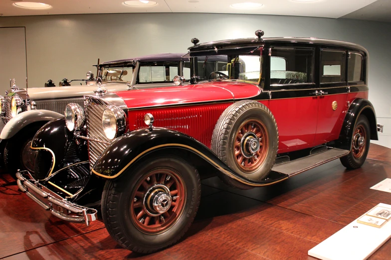 old vintage cars sit on display inside a museum