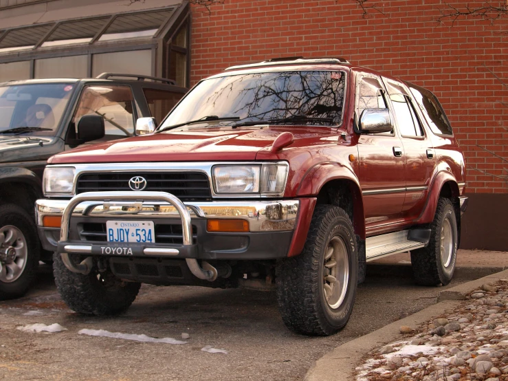 a red vehicle parked on the side of the road