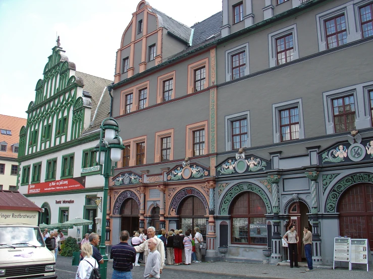 people standing in front of many large building