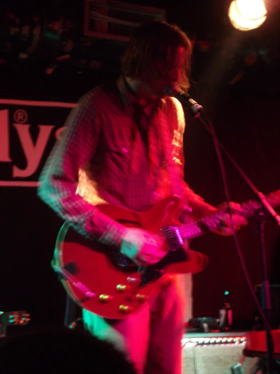 a man with a guitar plays a concert