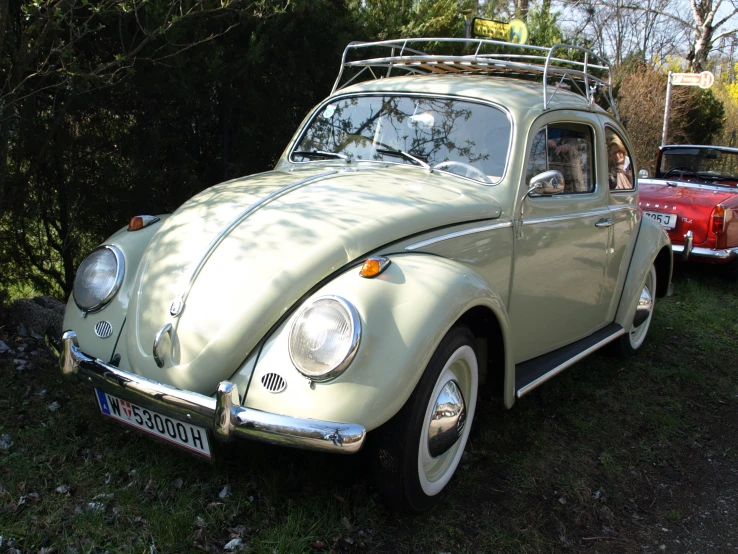 a vintage car with a surfboard on the roof