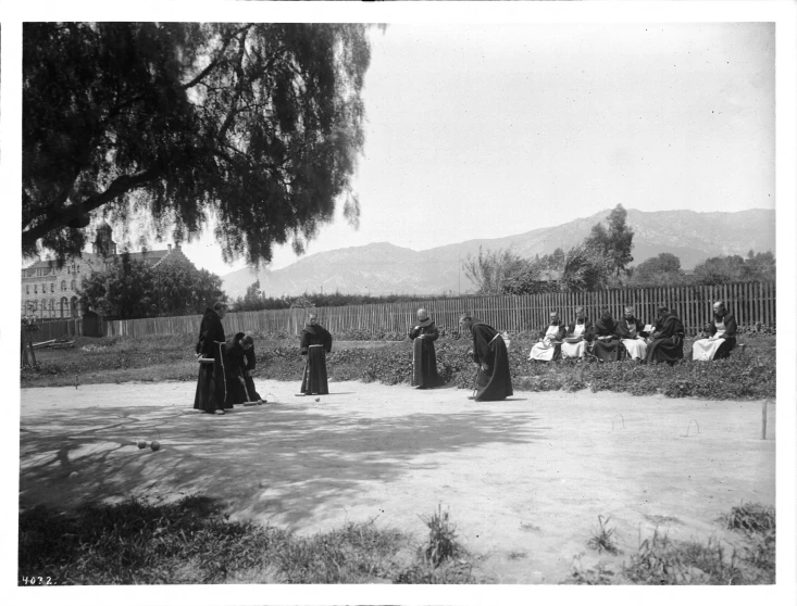 an old po of people sitting in the grass