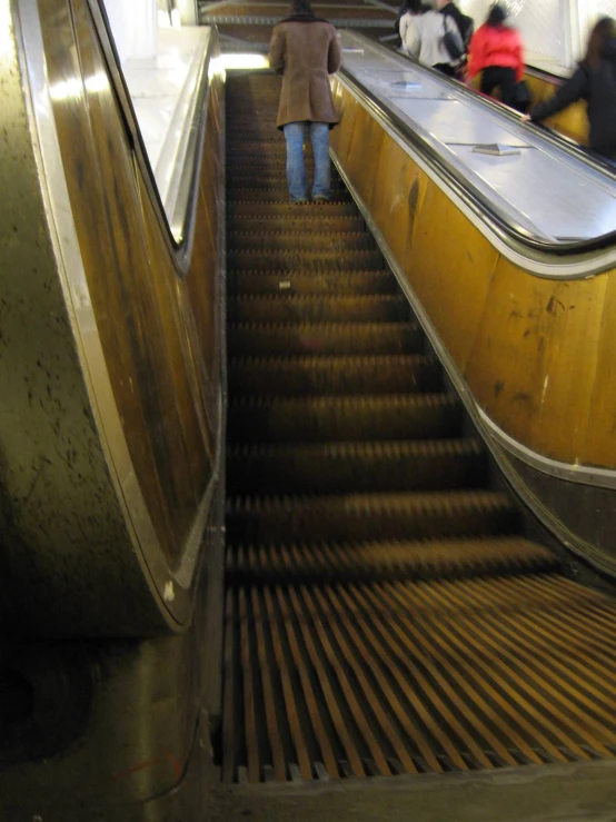 a large escalator with people moving down it