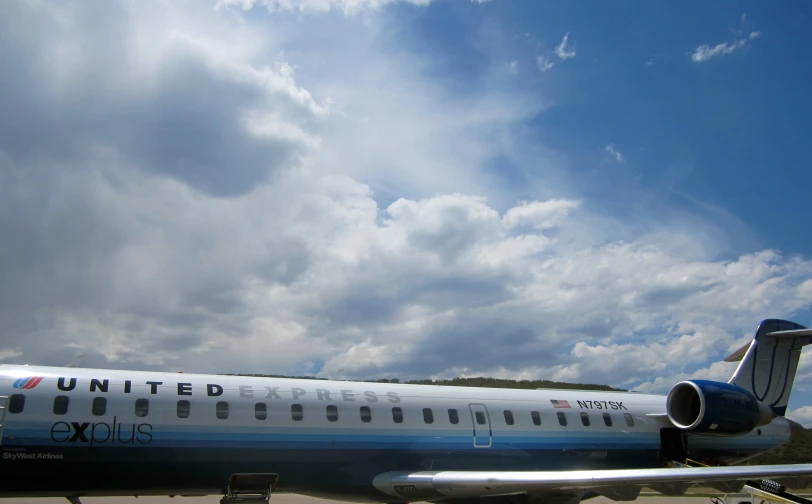 a united airline airplane sitting on the runway