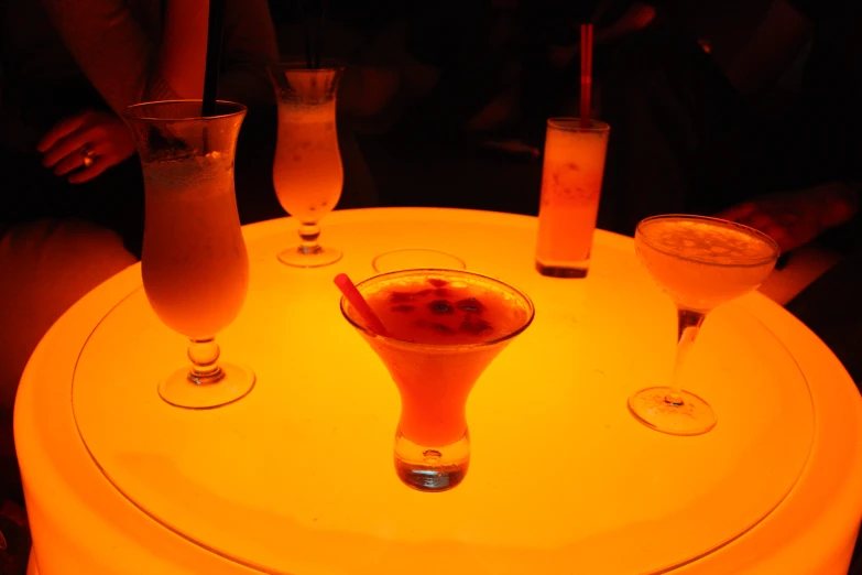 an assortment of drinks sitting on top of a round table