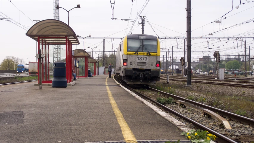 a train that is on the tracks near an empty station