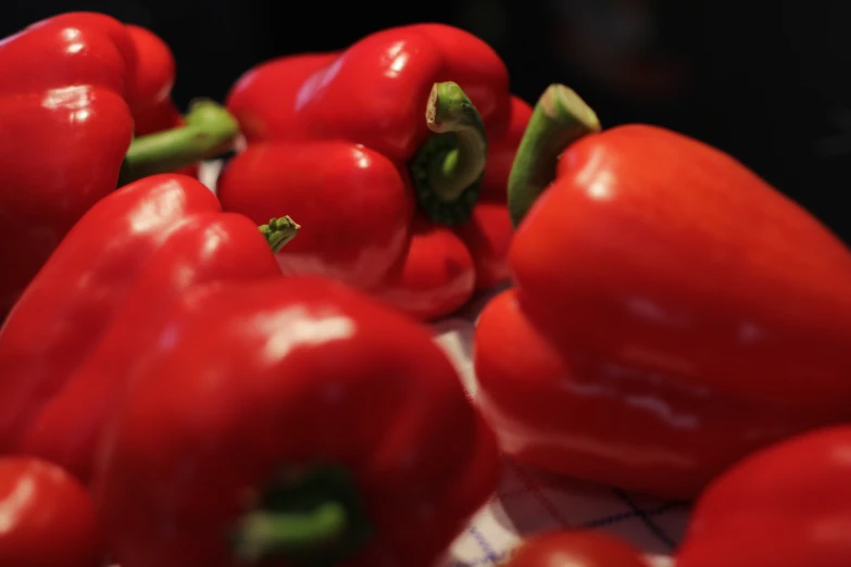 a bunch of red peppers sitting next to each other