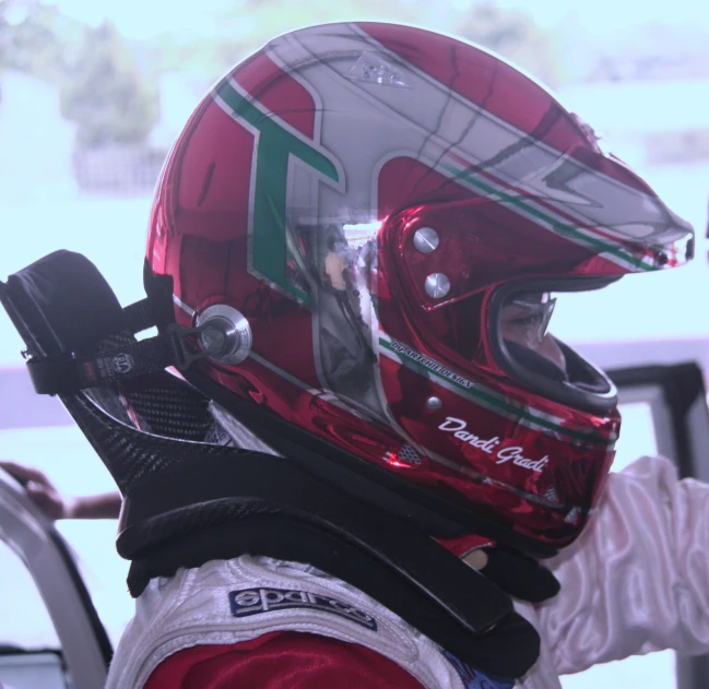 a person in a red helmet and white and green jacket