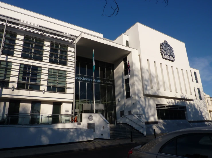 a large white building with windows and a number of steps