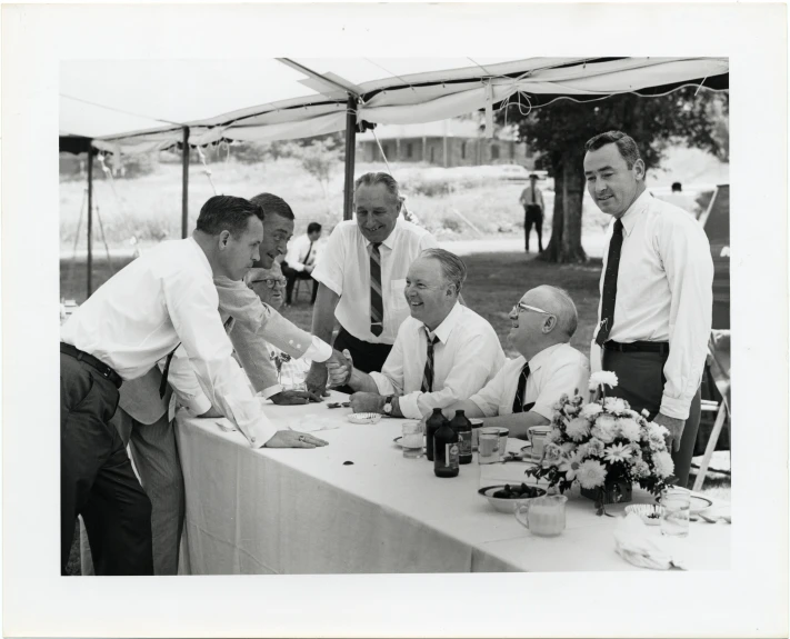 a group of men at a table having a meeting