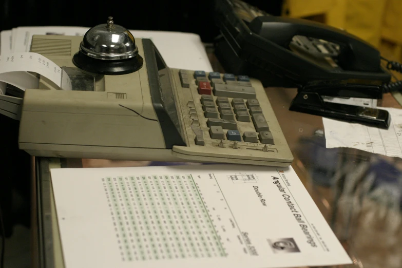 a calculator and some documents sit on a desk