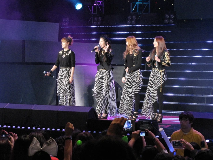 girls performing on stage in front of an audience