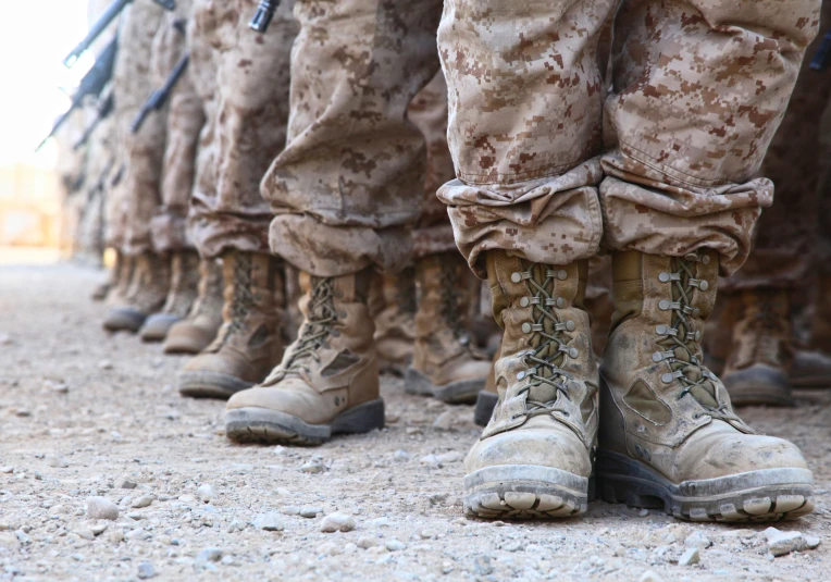 a row of men with boots and pants on