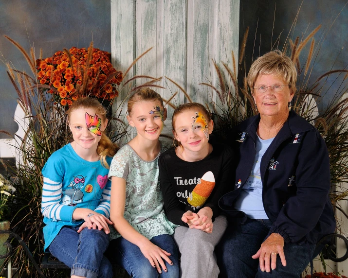 a woman and her three children smile for the camera