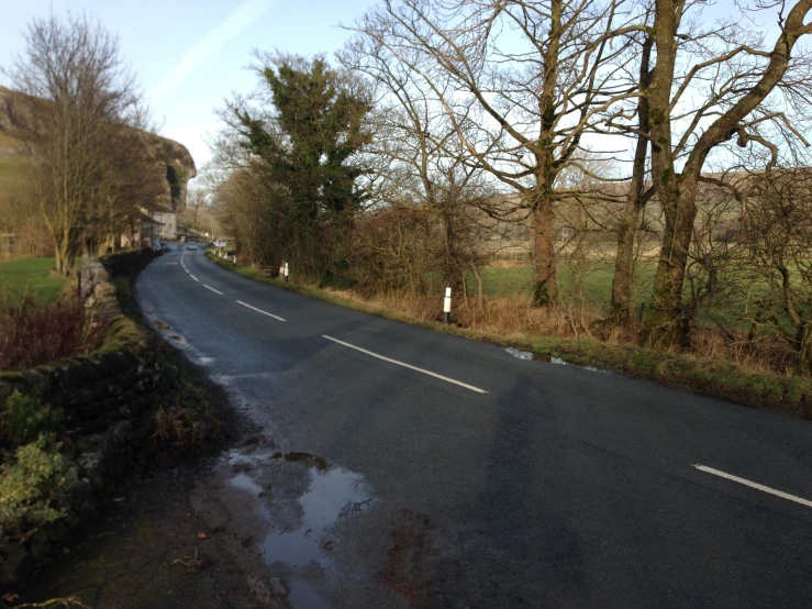 an empty road in the country with lots of trees