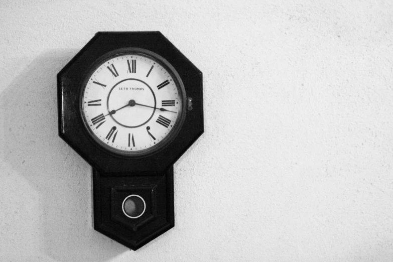 a small clock mounted to a wall on the wall