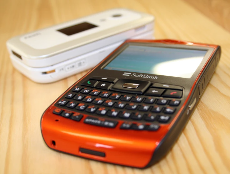 two phones are sitting side by side on a table