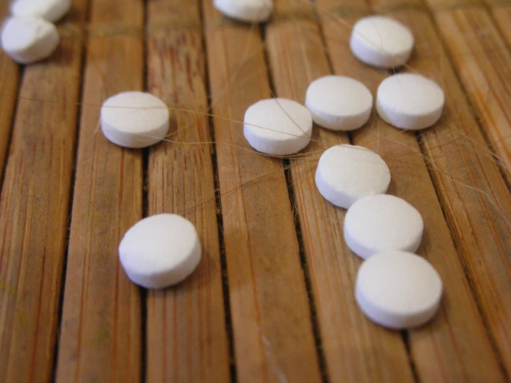 some pills are being laid out on a wooden table