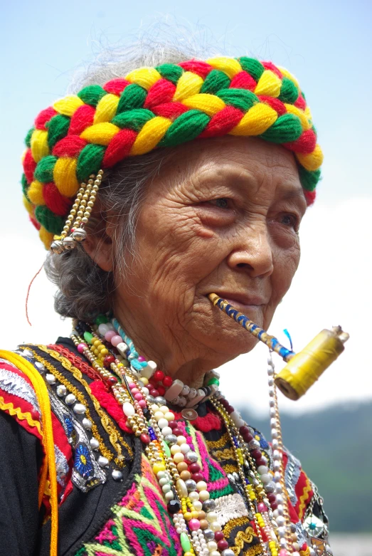 the colorful headpiece on this woman is decorated with beads