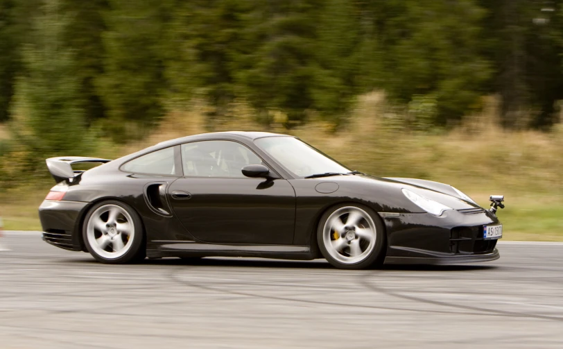 a black sports car driving down a street