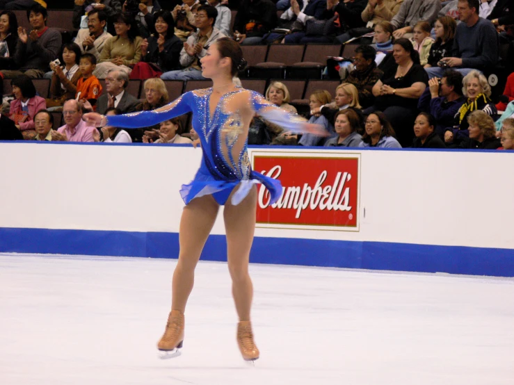 a girl performing in an ice skating competition