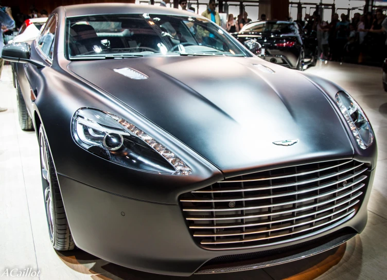 a silver sports car sitting on top of a hard wood floor