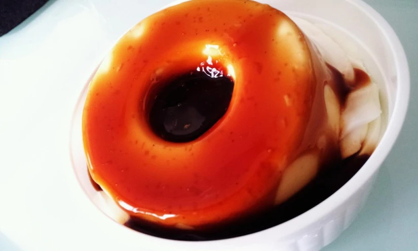 a doughnut with soing in it inside a white bowl