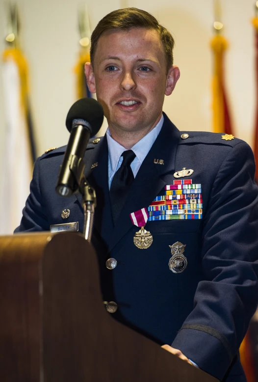 a man in uniform speaking into a microphone