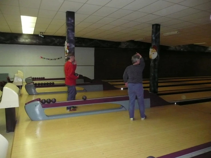 a group of people standing on top of a wooden floor