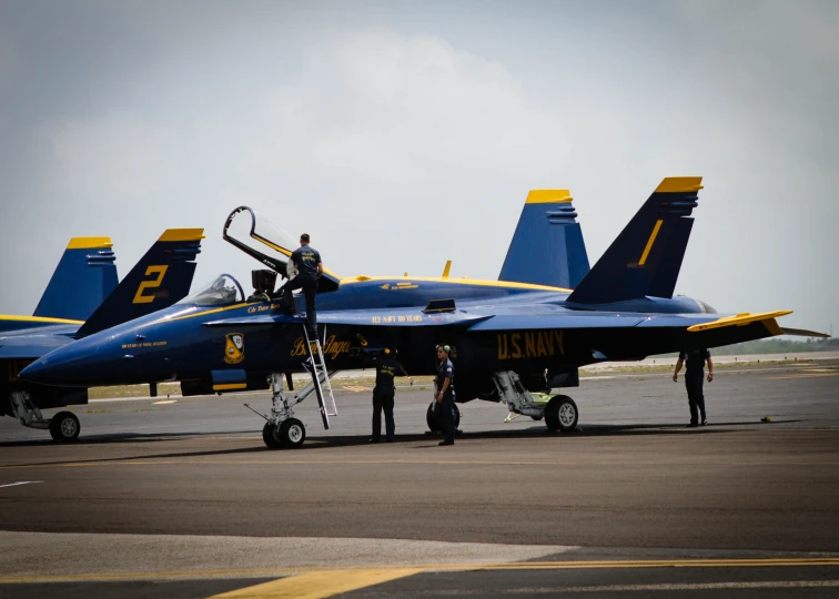 a fighter jet sitting on top of an airport runway